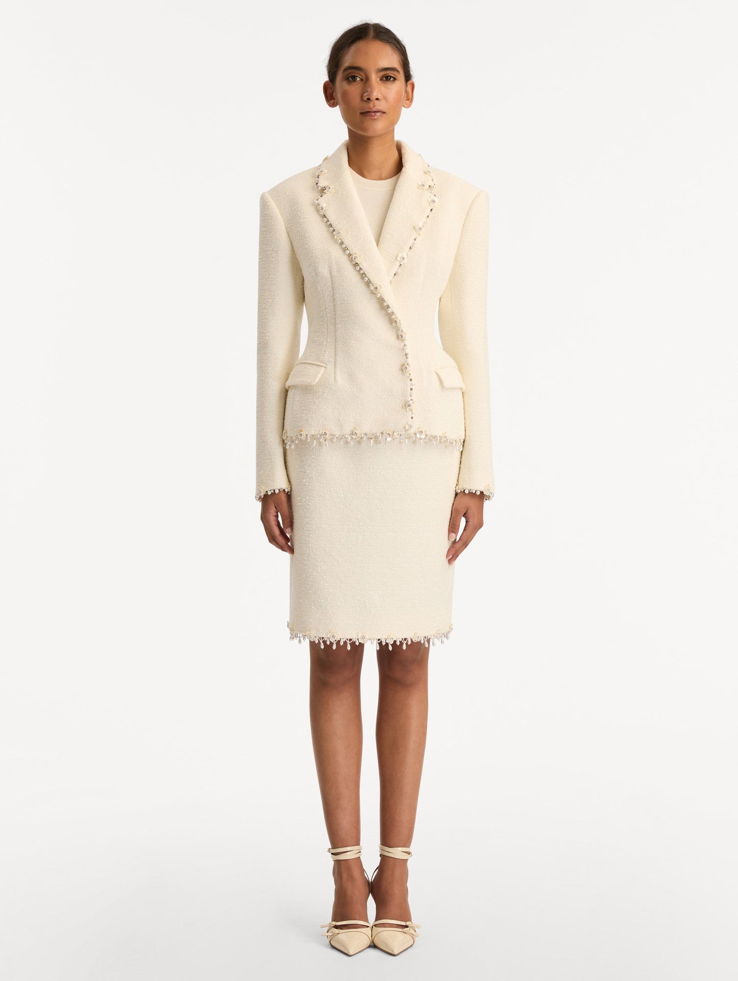 White Floral Jeweled Fringe Tweed Jacket featuring a fitted silhouette with jeweled applique along hems. Front View.