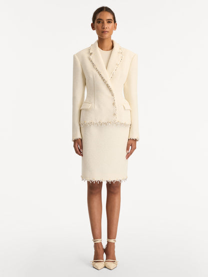 White Floral Jeweled Fringe Tweed Jacket featuring a fitted silhouette with jeweled applique along hems. Front View.
