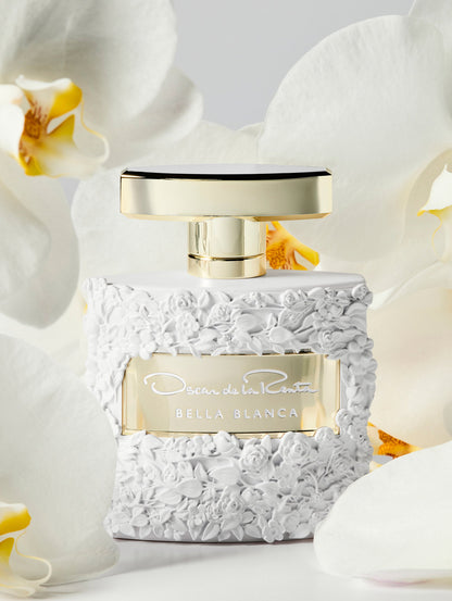 Oscar White Rose Texture Bella Blanca Perfume Bottle Surrounded by White Orchids Front View