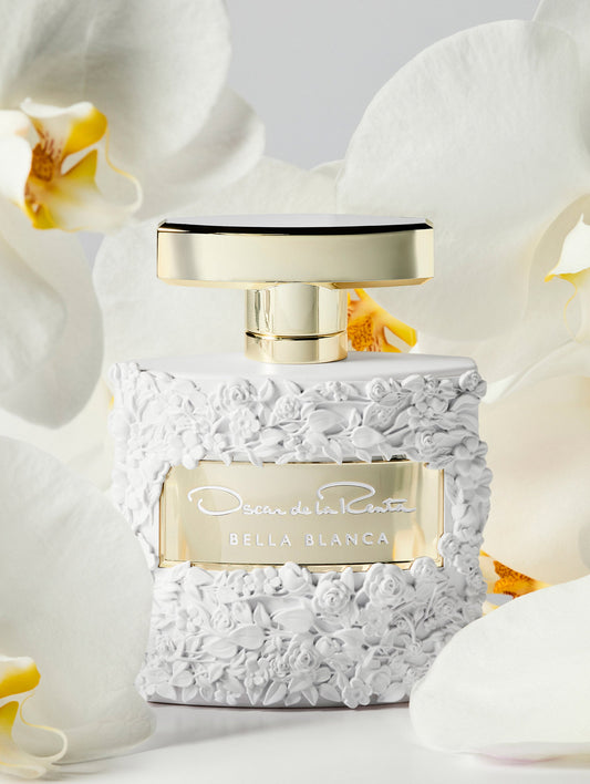 Oscar White Rose Texture Bella Blanca Perfume Bottle Surrounded by White Orchids Front View