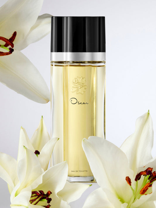 Oscar Perfume Bottle with Black Cap Surrounded by Lilies Front View