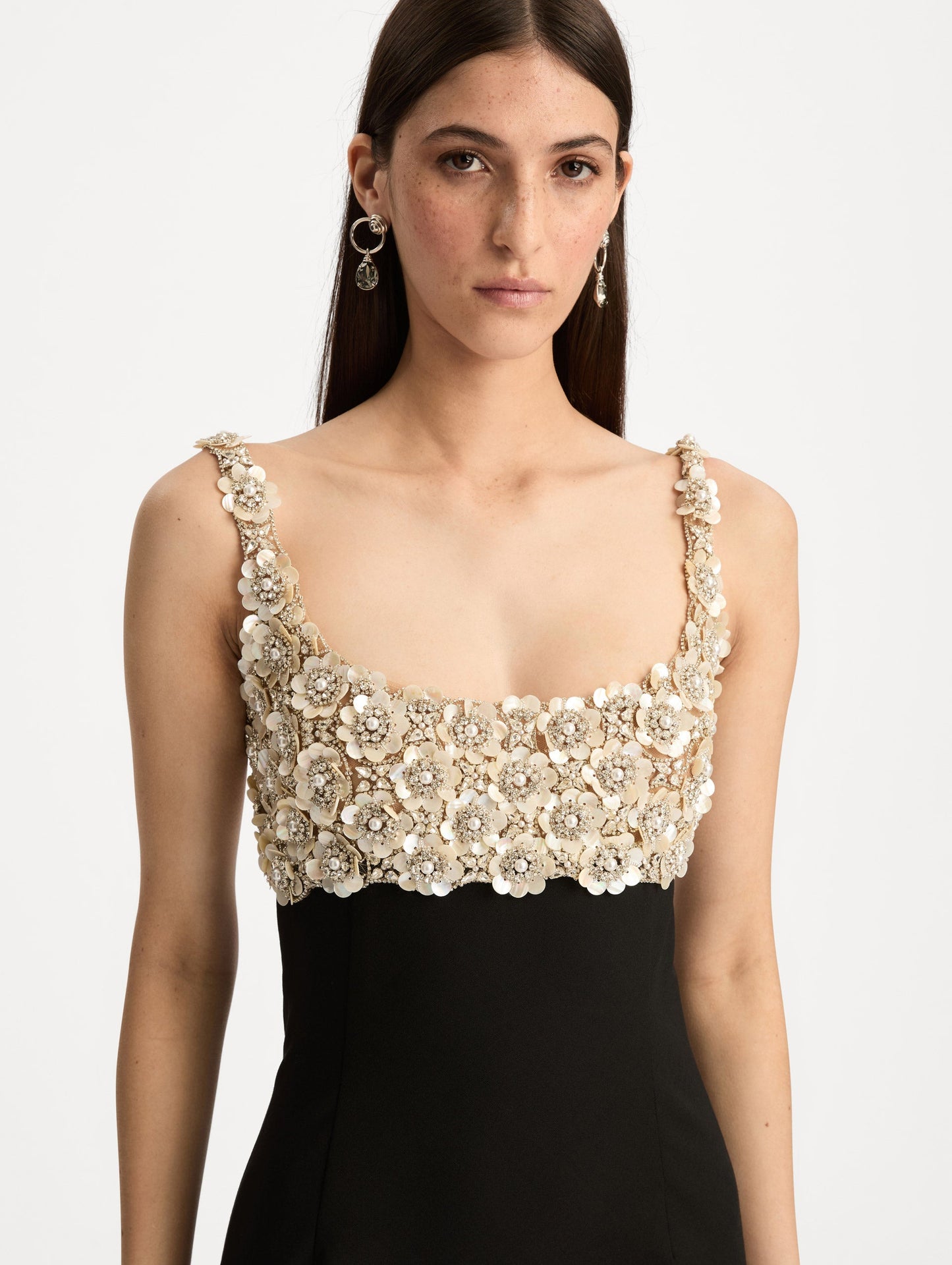 Black Embroidered Sleeveless Gown with a form fitting, floor length silhouette and an embellished bodice. Zoom View.