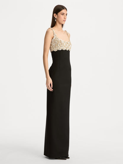 Black Embroidered Sleeveless Gown with a form fitting, floor length silhouette and an embellished bodice. Side View.