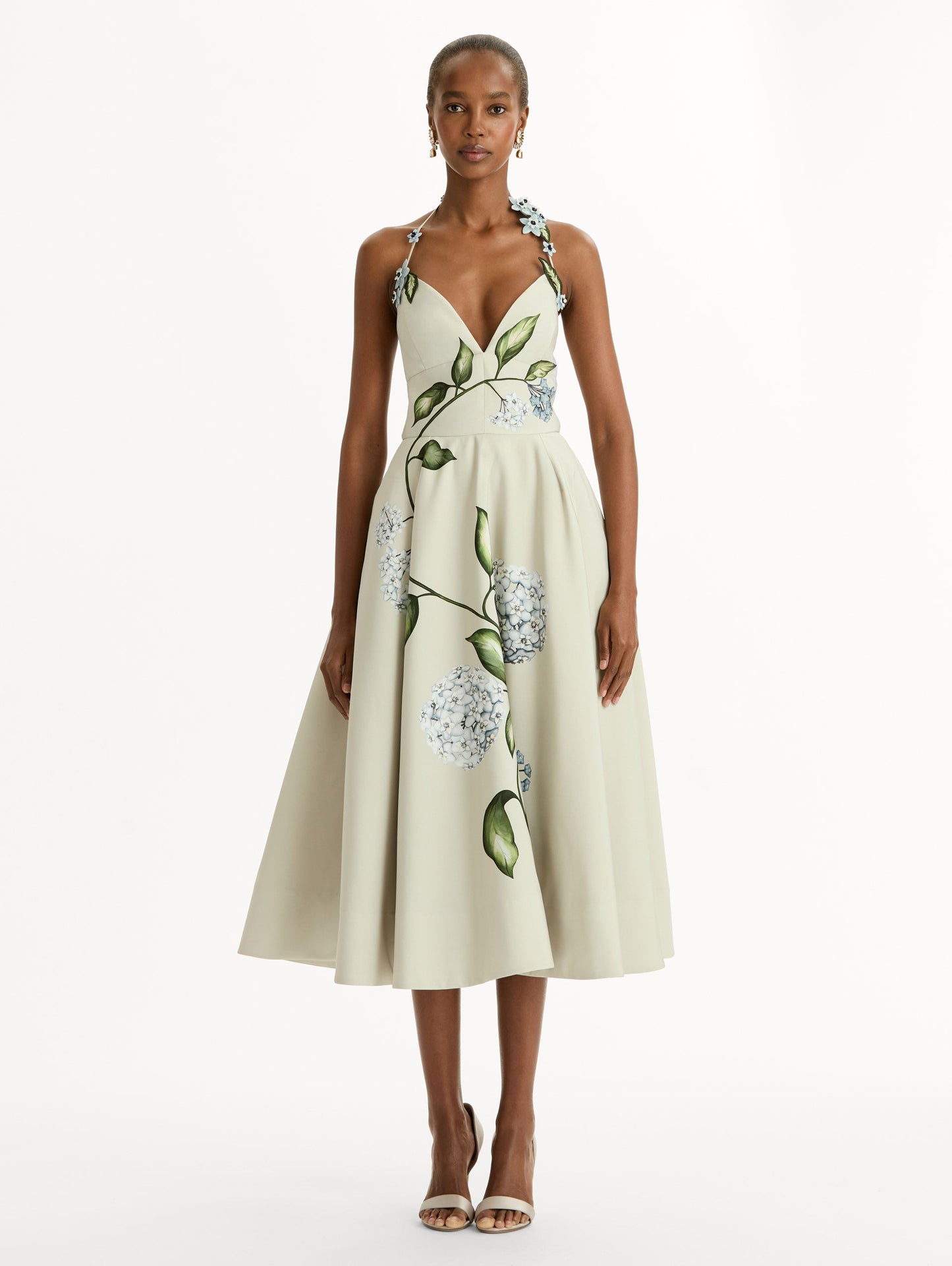 Porcelain flower-printed faille cocktail midi dress with floral appliqué halter neckline. Fitted bodice and full skirt. Front View.