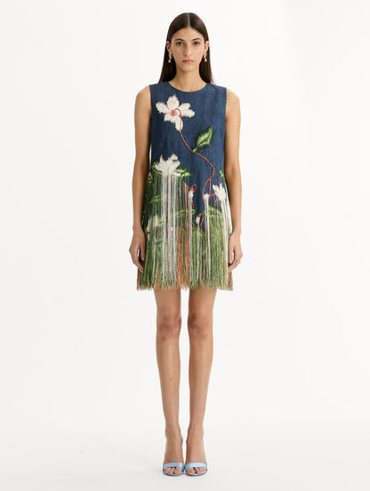 Denim, mini shift dress with Chiné Cyclamen motif and cascading threadwork fringe. Sleeveless. Front View.