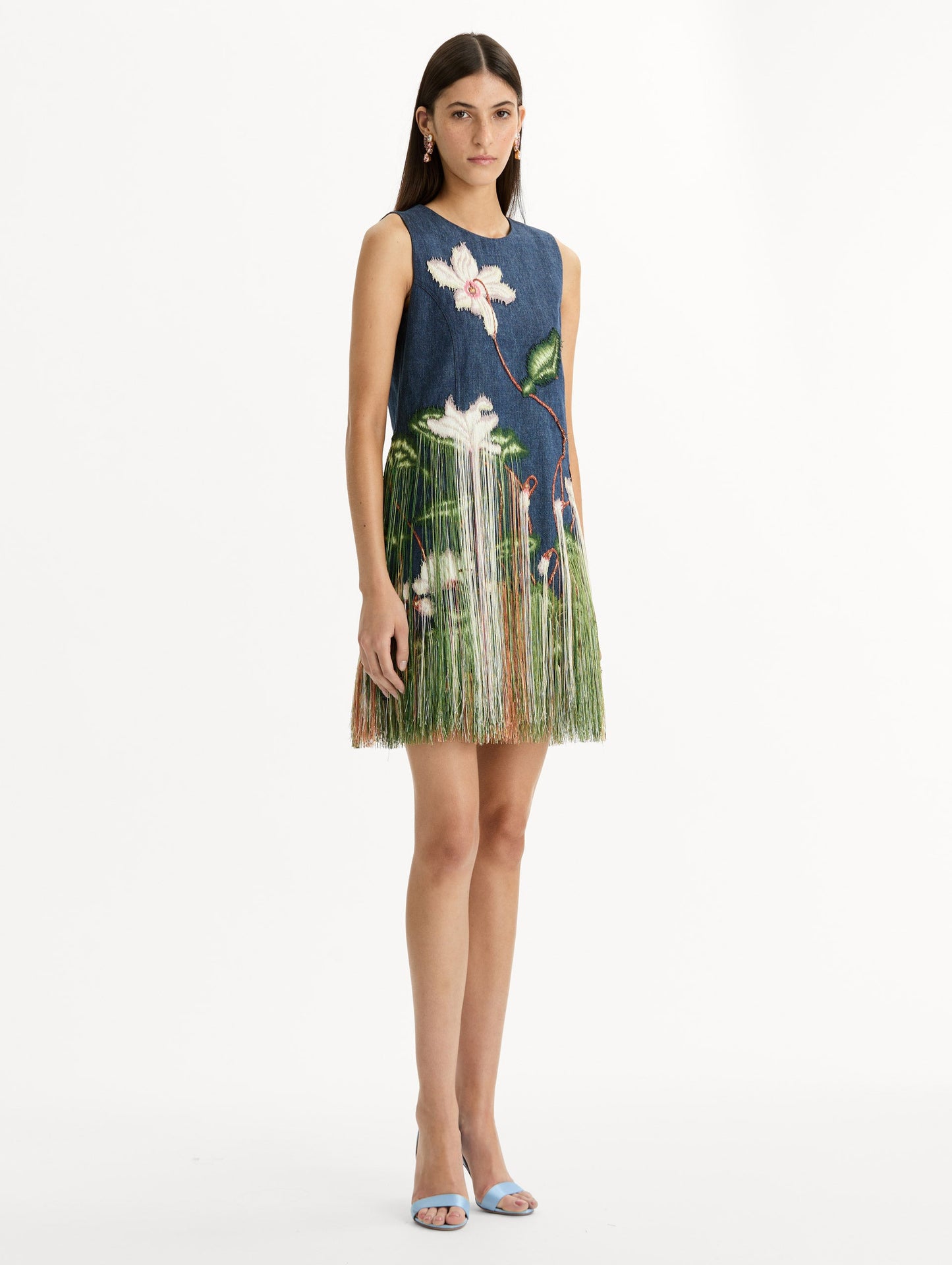 Denim, mini shift dress with Chiné Cyclamen motif and cascading threadwork fringe. Sleeveless. Side View.