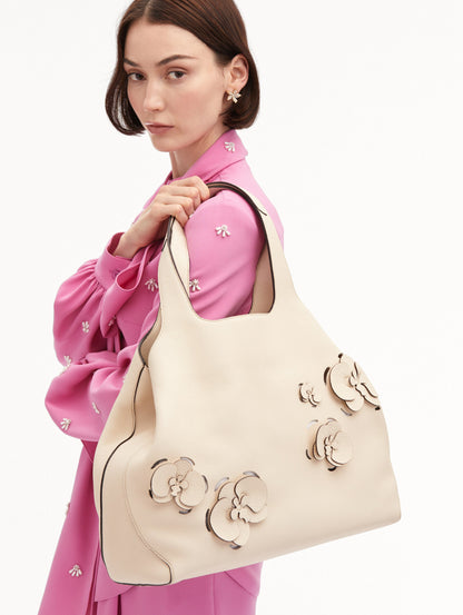 The Laser-Cut Orchid Topaz Tote in Ivory Front View