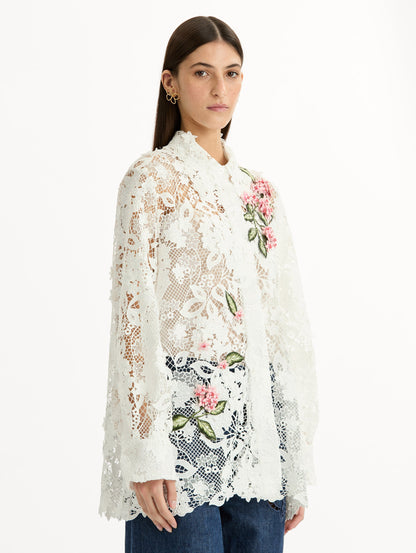 Long Sleeve, Button Up Blouse with Delicate guipure lace and intricate porcelain flower embroidery. White with pink florals. Side View.
