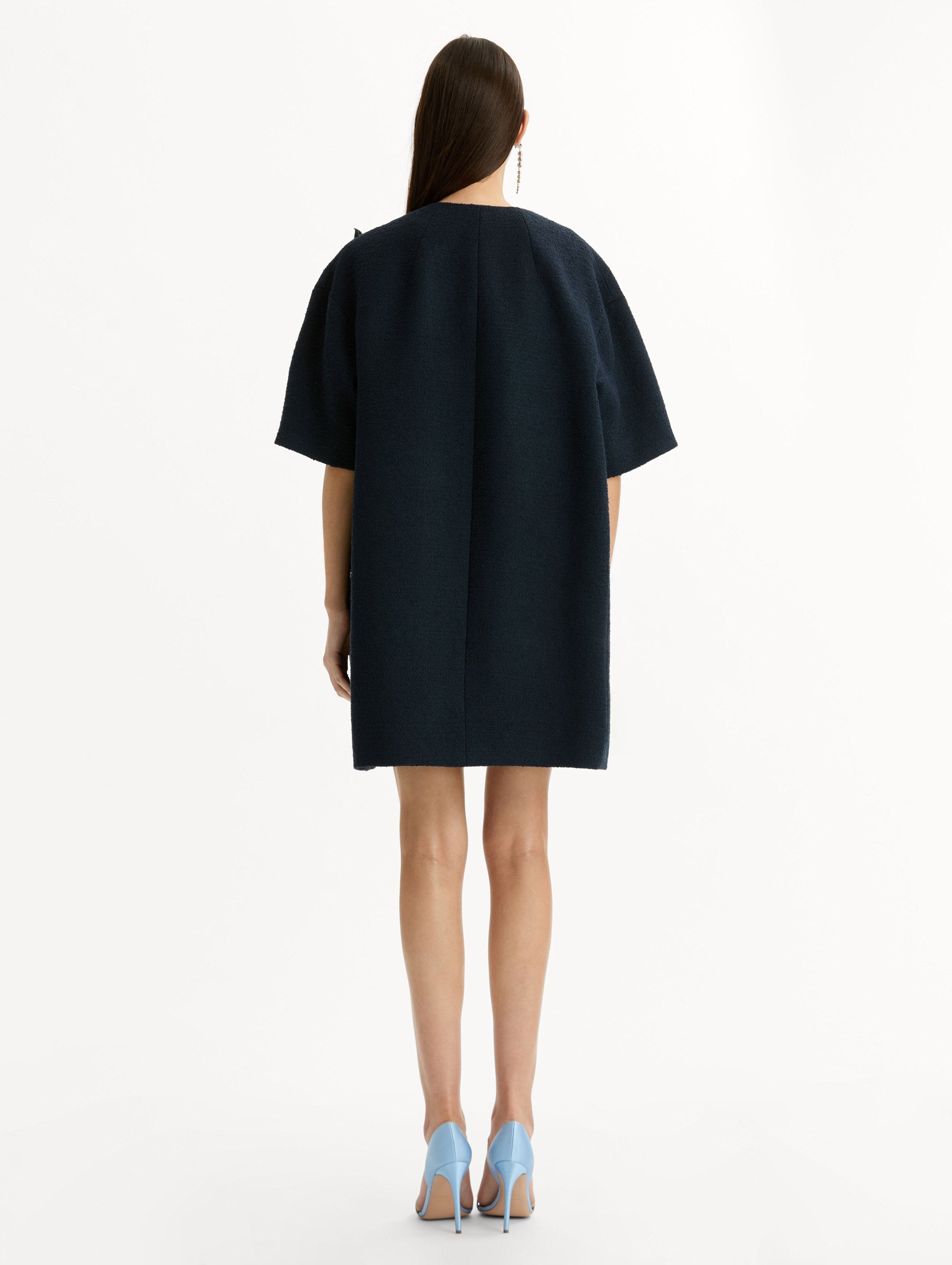Short sleeve, navy tweed coat with porcelain flower embroidery. Floral motifs cascade across the front. Back View.