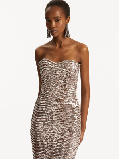 Model wearing soft pink strapless sequin wave embellished gown. Zoom view
