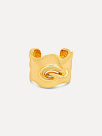 Sculptural gold cuff features a twisted abstract interpretation of the Oscar “O” emblem with an undulating curve and polished finish