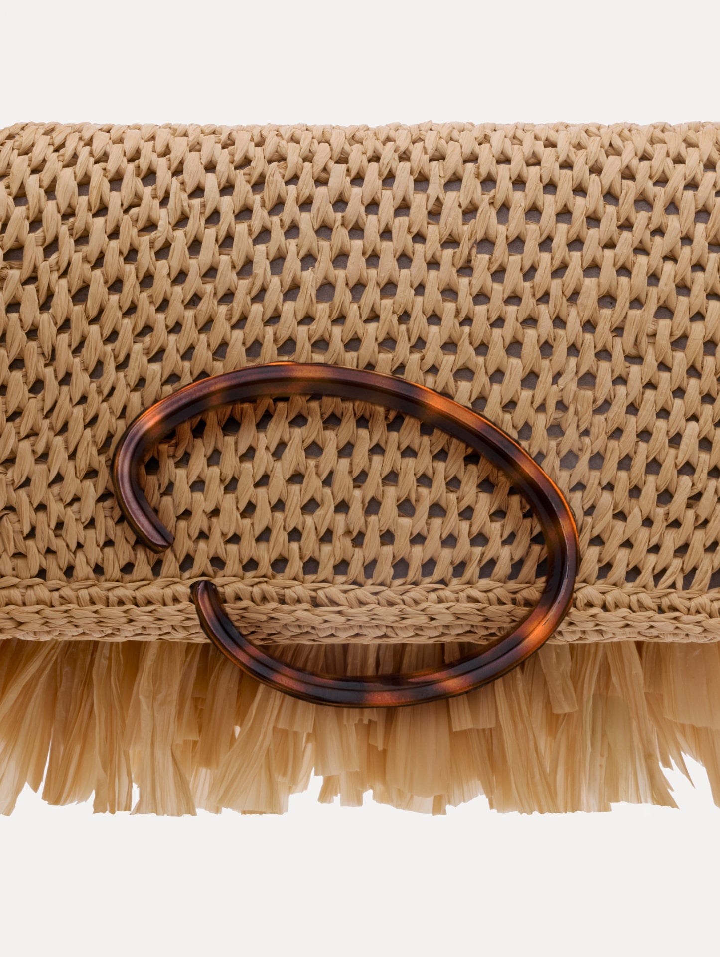 The Raffia Fringe O Pochette in the color natural with fringe detailing and a tortoise-accented O clasp.