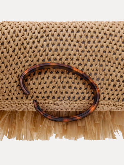 The Raffia Fringe O Pochette in the color natural with fringe detailing and a tortoise-accented O clasp.
