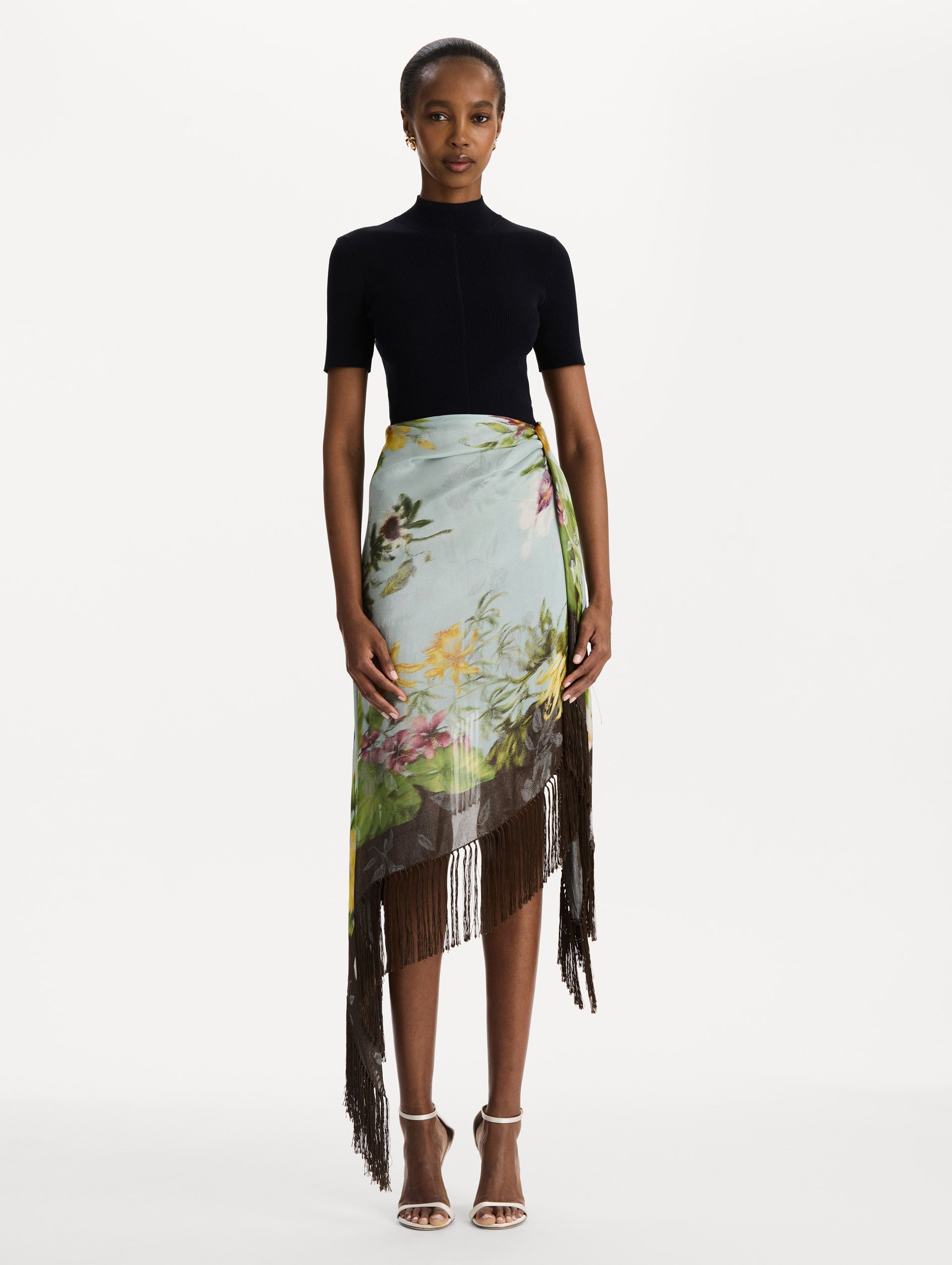 Dominican Mixed-Floral Fringe Skirt in Light Blue Multi. Front View.
