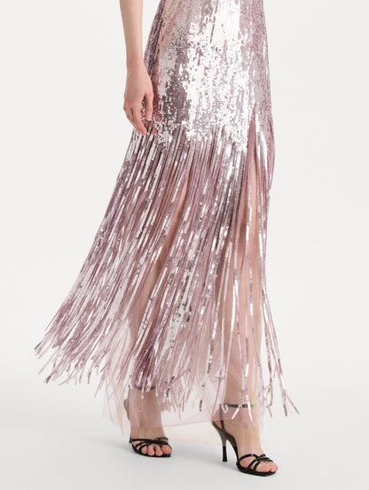 The model is wearing the Sequin Fringe Strapless Gown in the color tulip pink featuring a strapless silhouette, all-over sequins, and fringe skirt. Detail Shot.