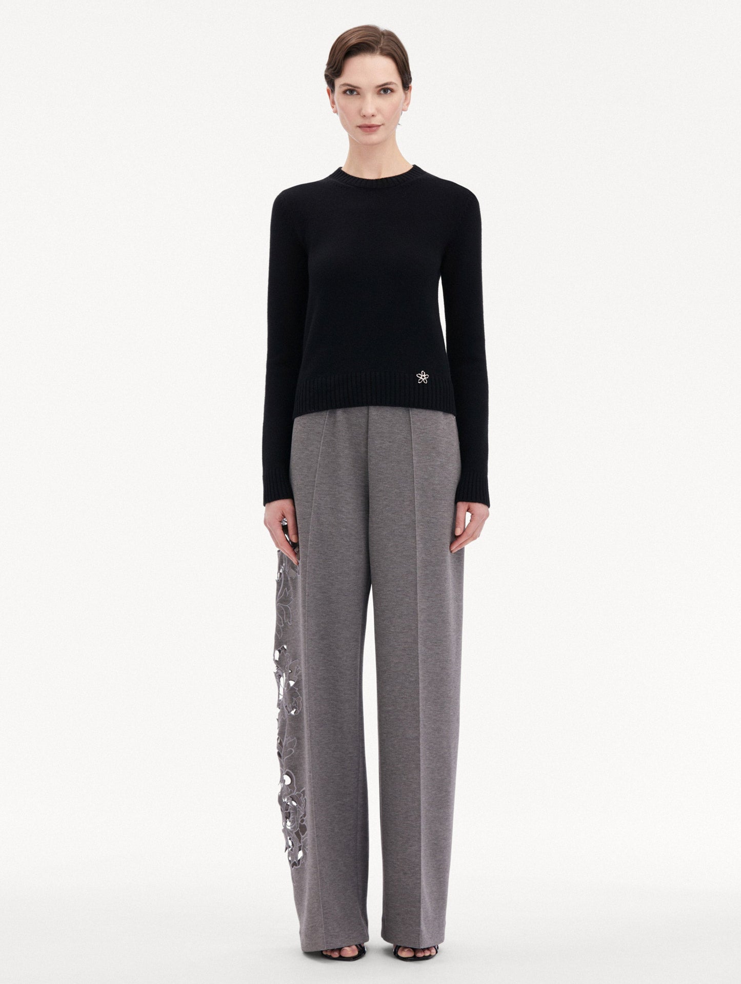 Black O Flower Cashmere Pullover Paired with Grey Trousers Front View