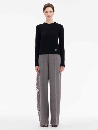Black O Flower Cashmere Pullover Paired with Grey Trousers Front View