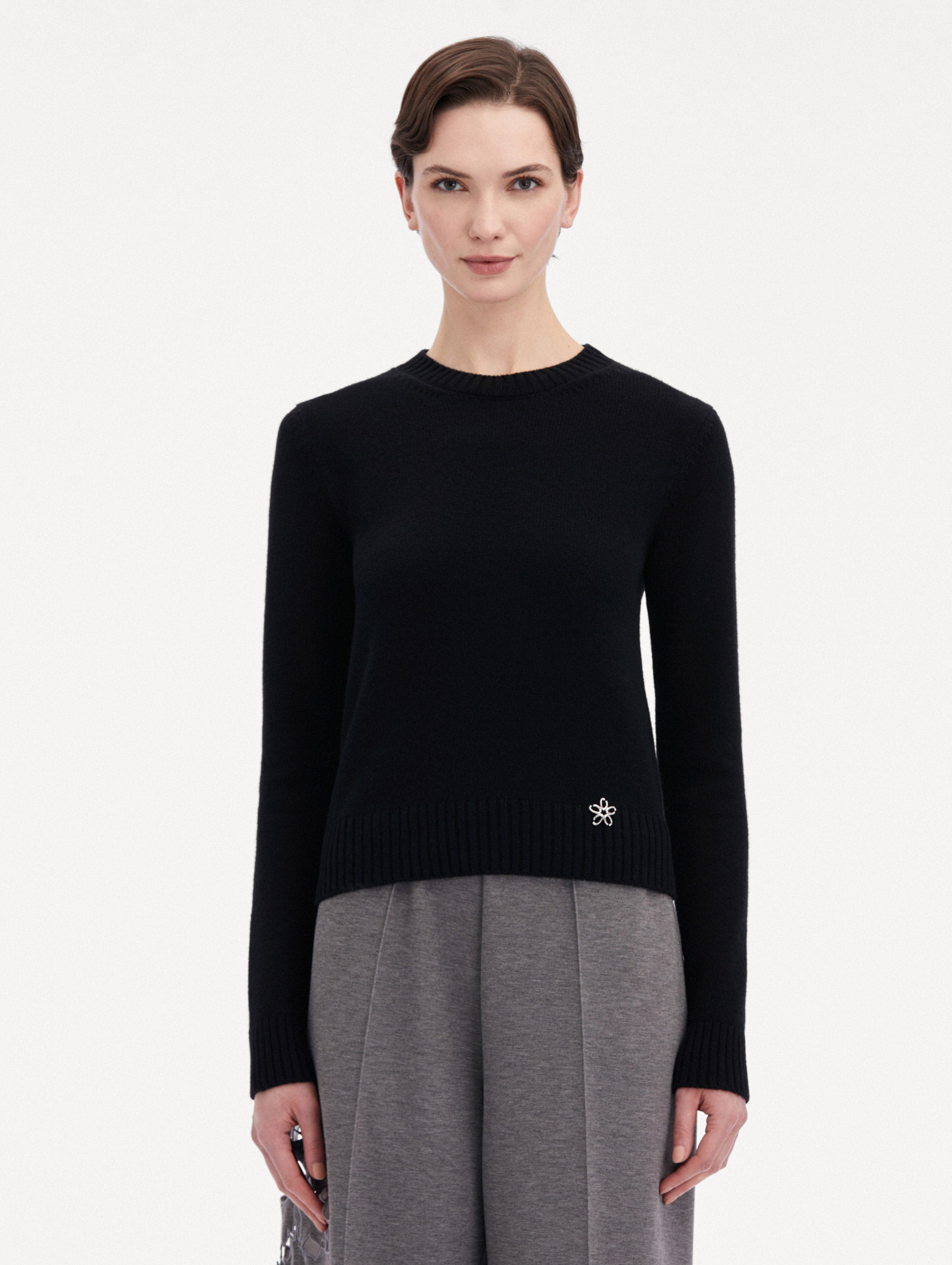 Black O Flower Cashmere Pullover Paired with Grey Trousers Front View