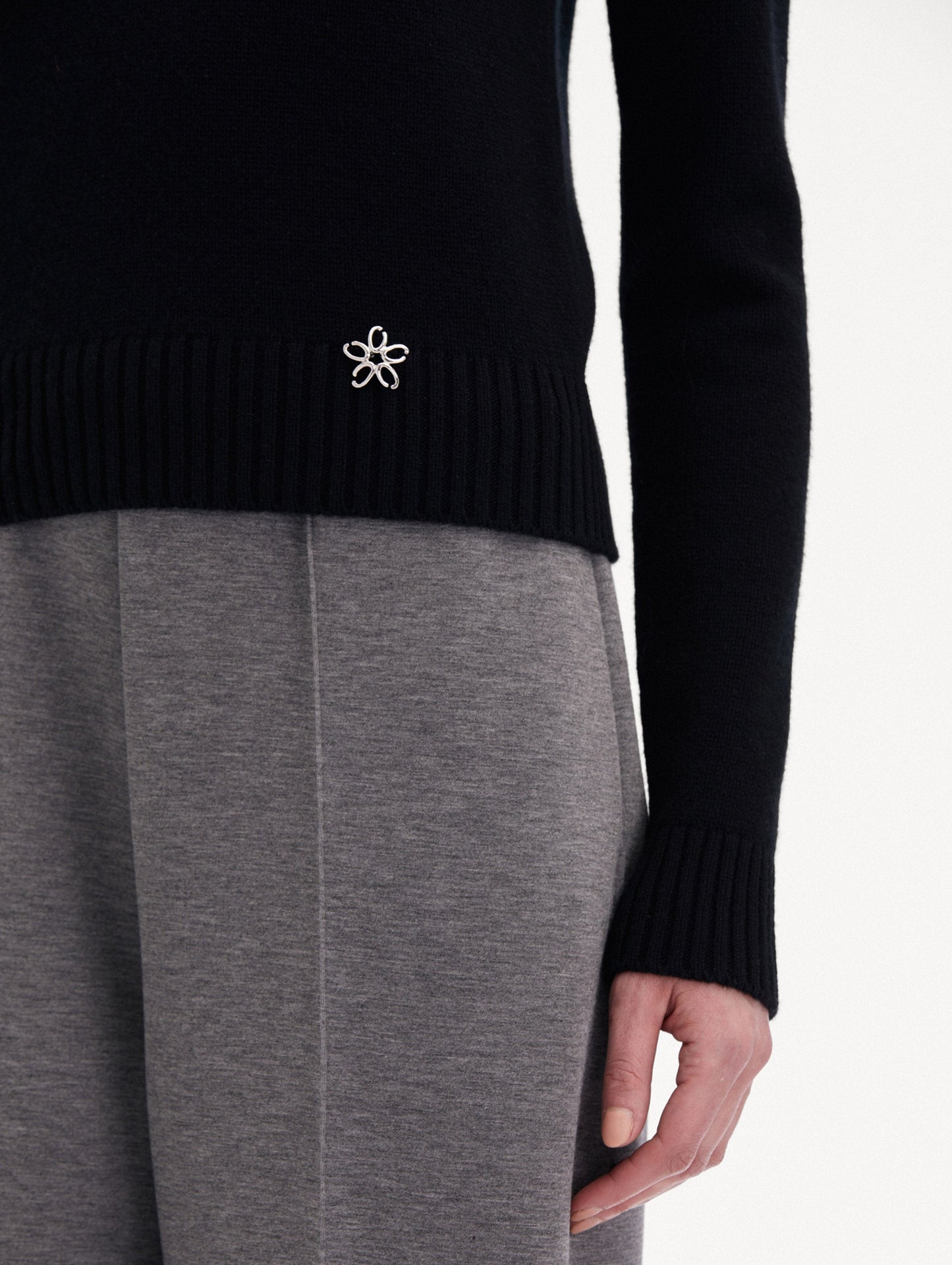Black O Flower Cashmere Pullover Paired with Grey Trousers Zoom View
