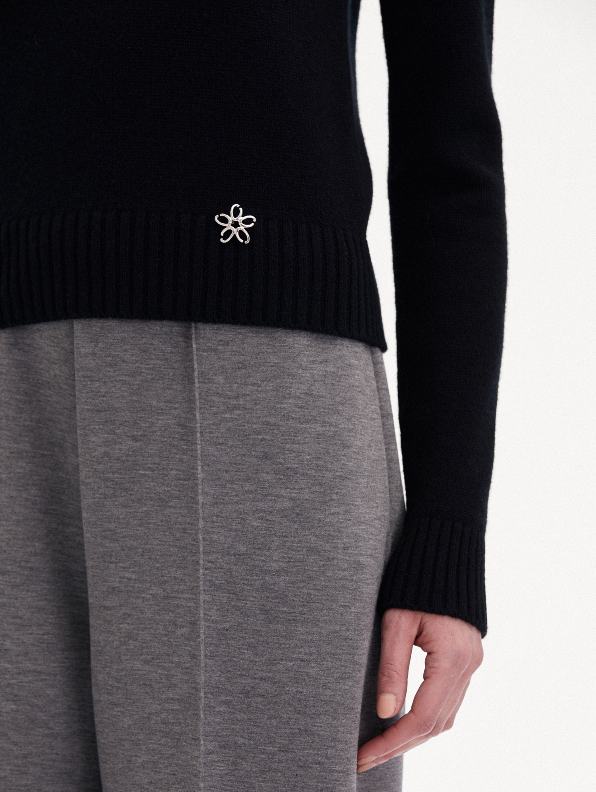 Black O Flower Cashmere Pullover Paired with Grey Trousers Zoom View