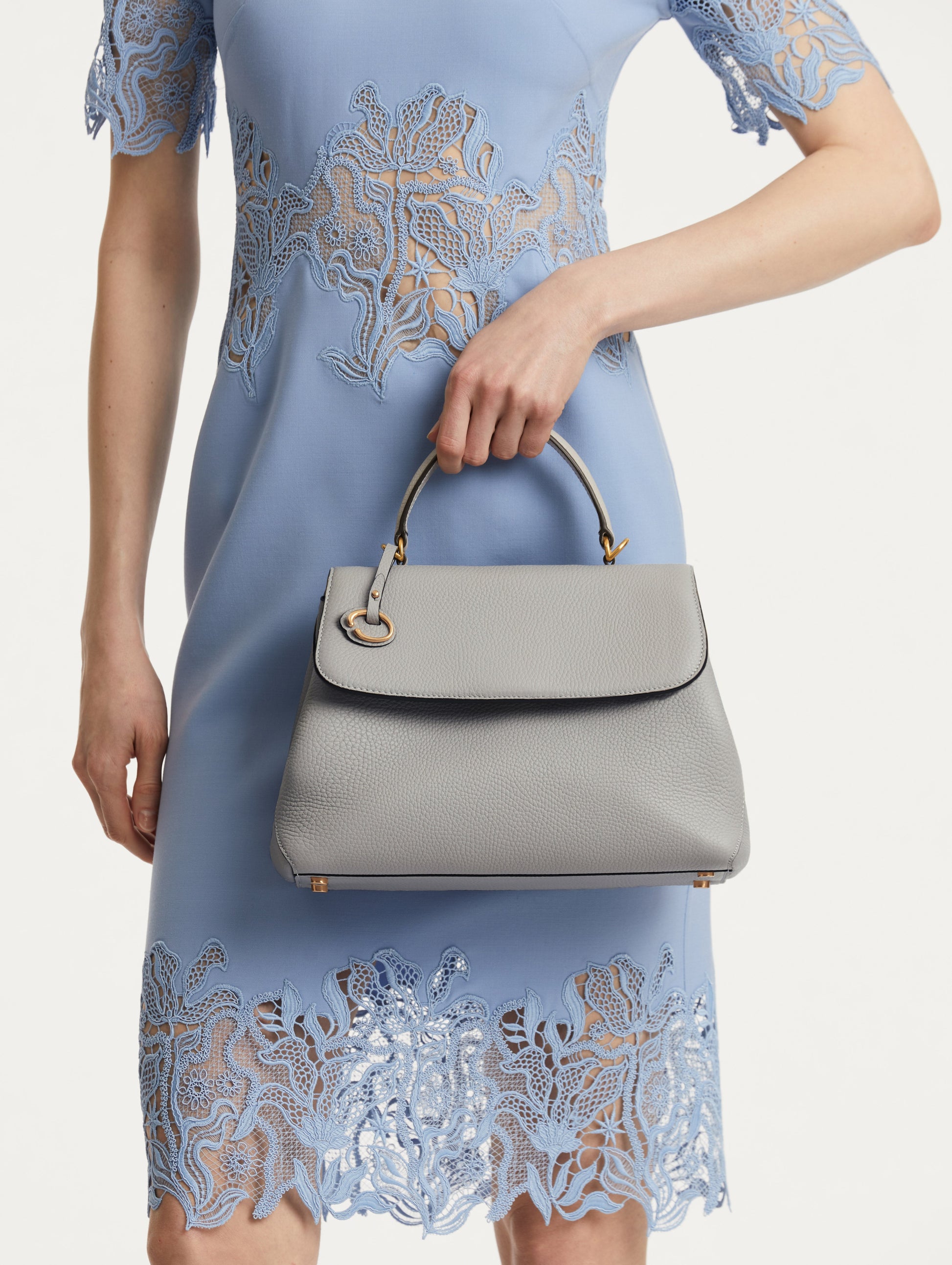 The Poppy Leather Handbag in Grey with O logo Tag around the Top Handle, and Detachable Shoulder Strap. Front View