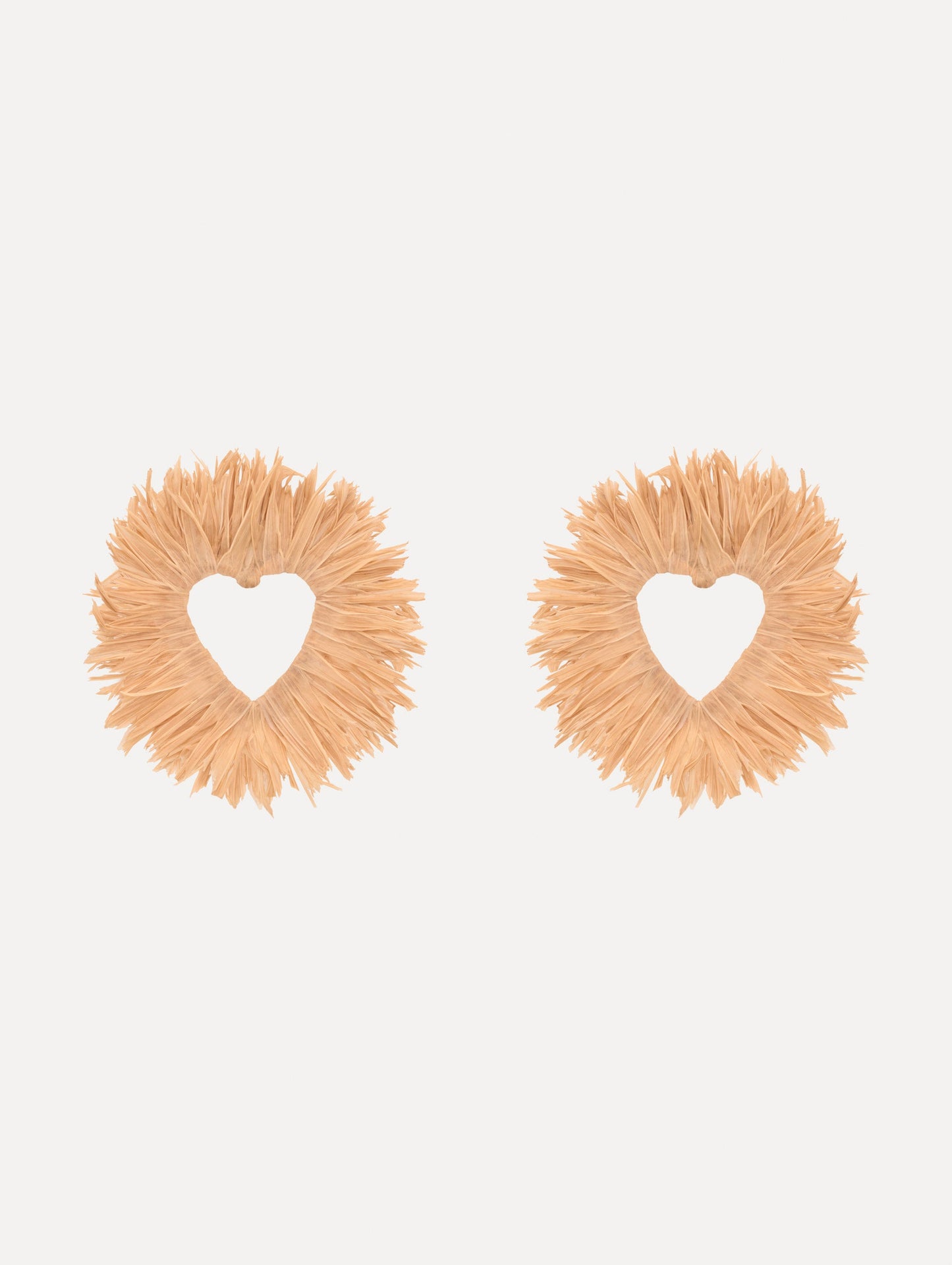 The Raffia Heart Earrings with heart cut-out center. Front View.