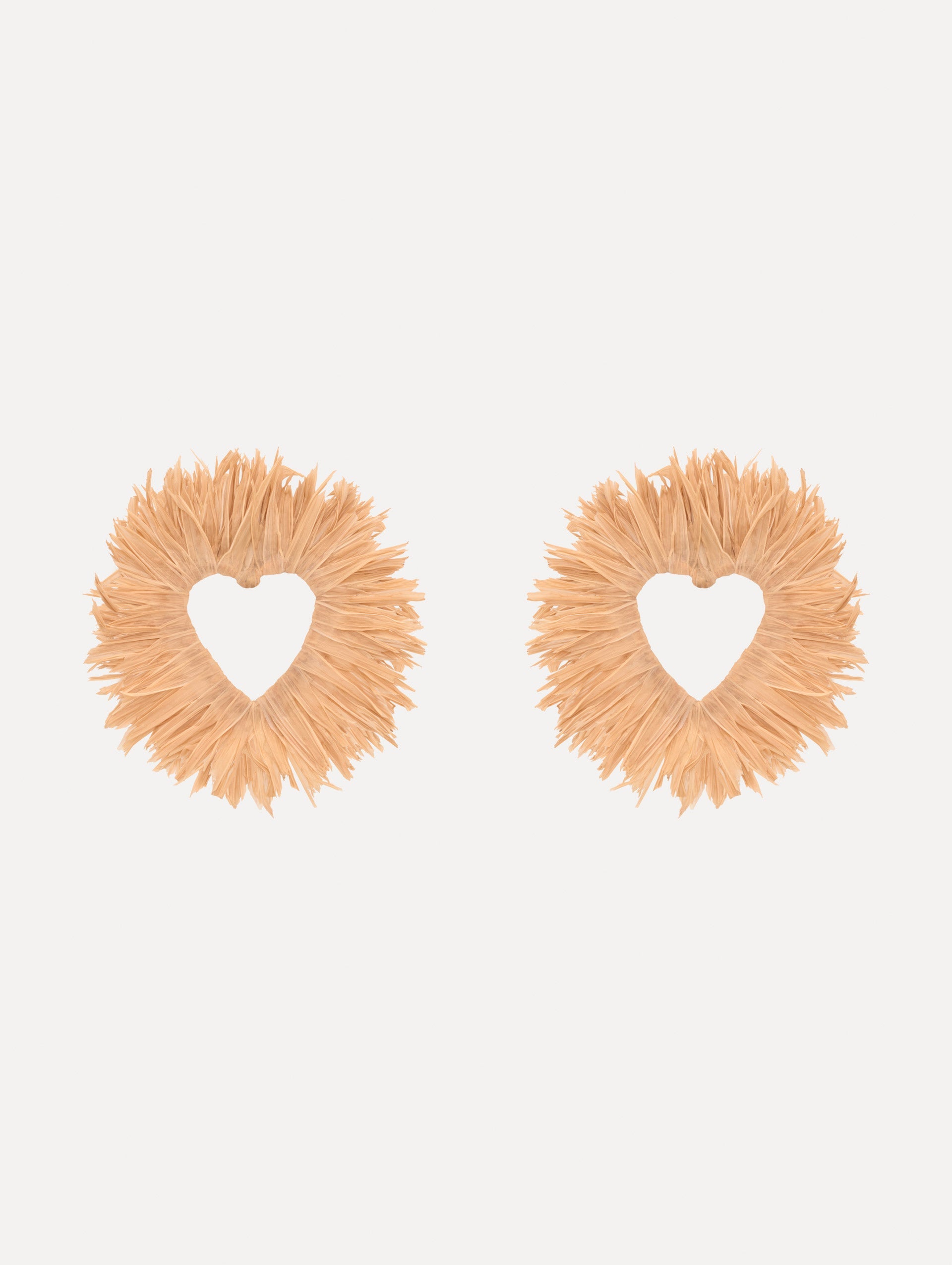 The Raffia Heart Earrings with heart cut-out center. Front View.