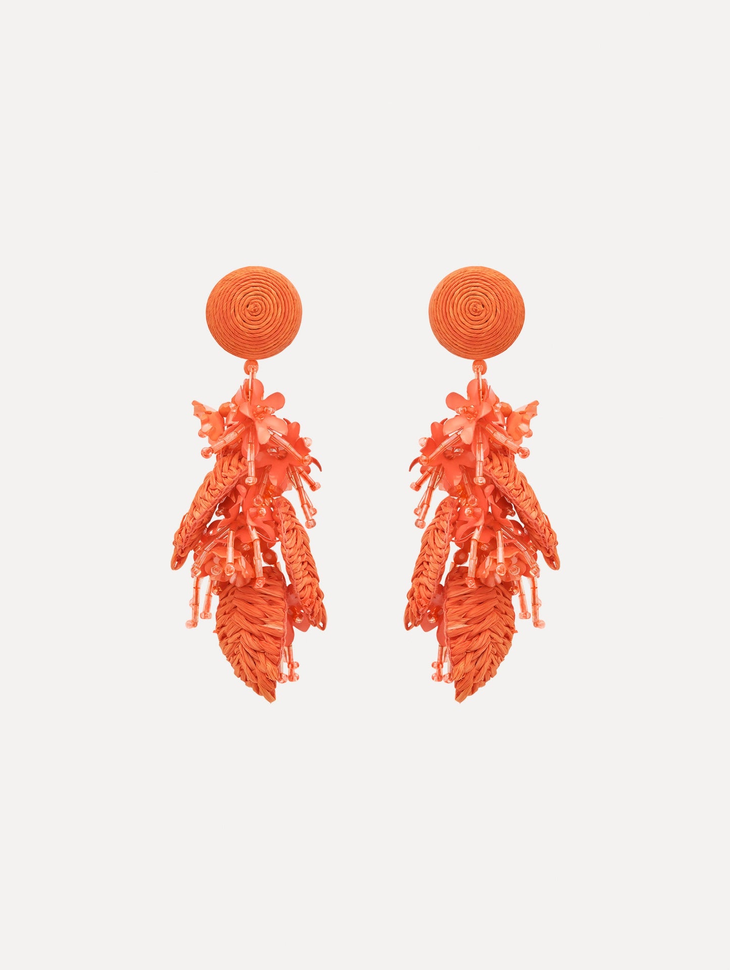 The Raffia Tassel Bouquet Clip-On Earrings in Orange. Front View.