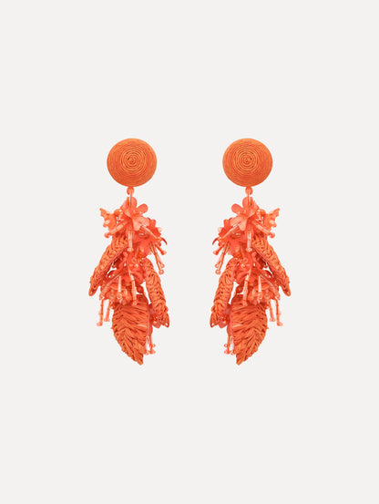 The Raffia Tassel Bouquet Clip-On Earrings in Orange. Front View.