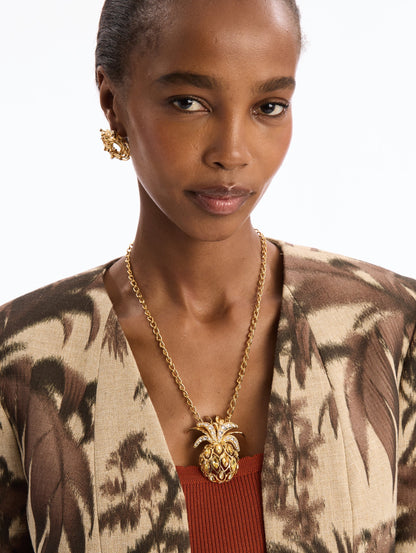 The model is wearing The Pineapple Pavé Pendant Necklace with crystal accents. Front View.