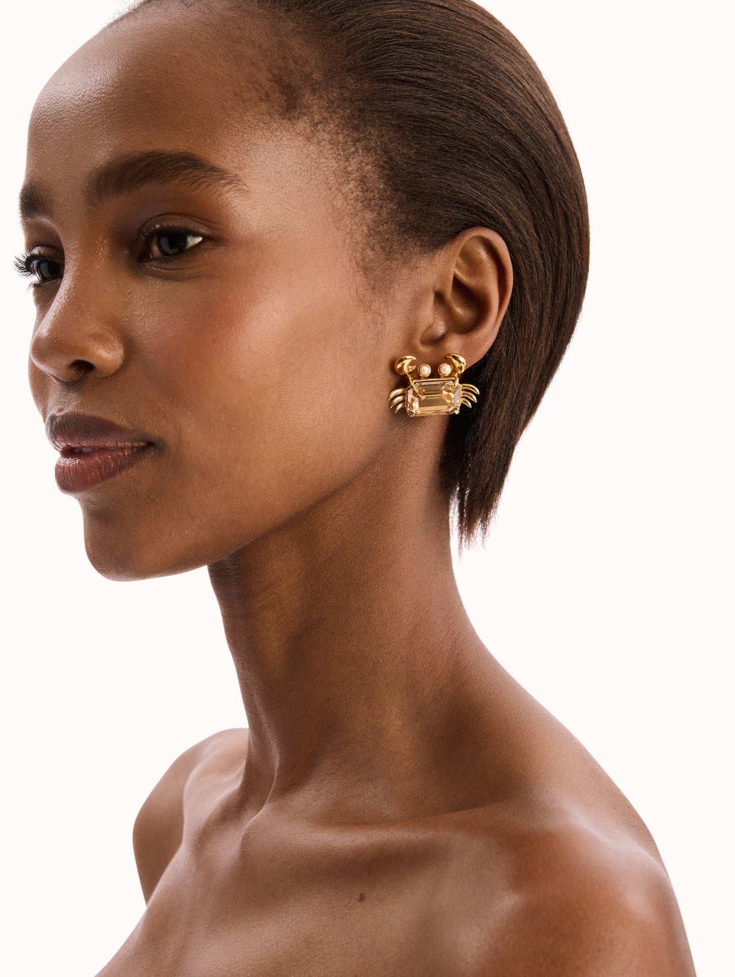 The model is wearing the Crystal Crab Earrings. Detail View.