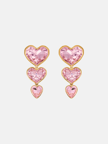 The Crystal Heart Drop Clip-On Earrings in Pink. Three vertically connected hearts with gold rims. Front View.