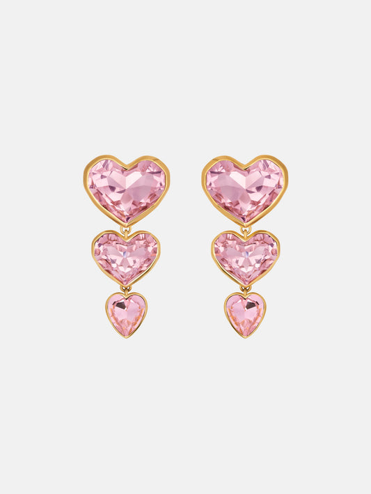 The Crystal Heart Drop Clip-On Earrings in Pink. Three vertically connected hearts with gold rims. Front View.