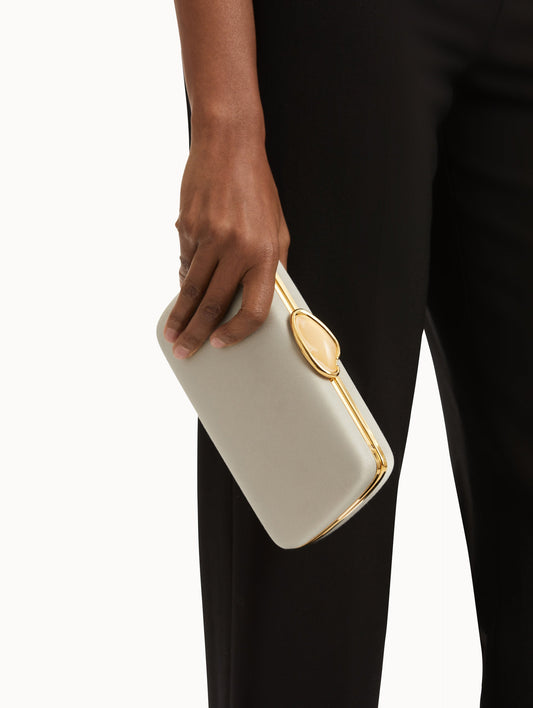 White Satin Minaudière adorned with Gold O Emblem at Clasp and removable chain shoulder strap. Front View