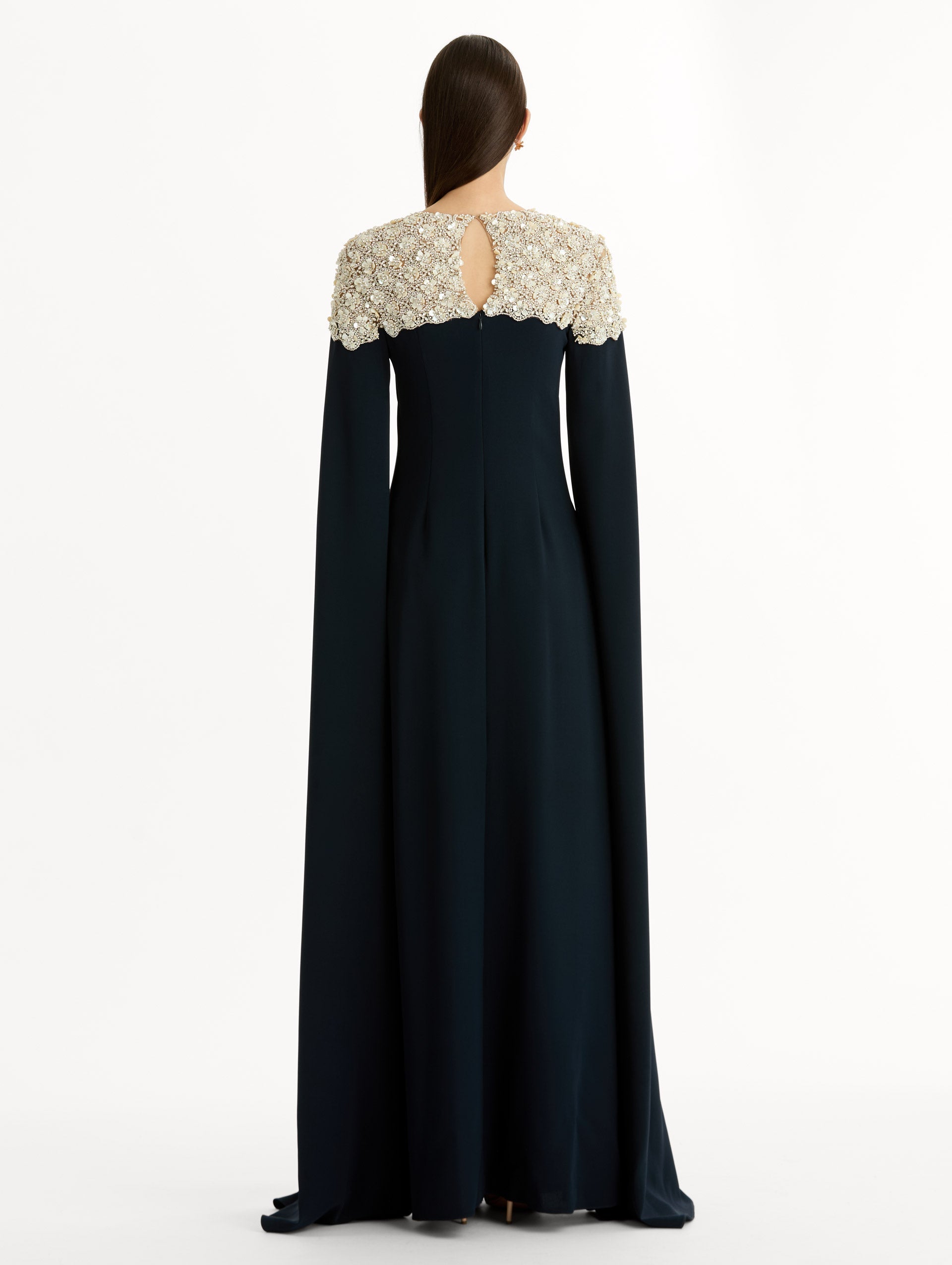 Navy Embroidered Caftan with ivory embroidered neckline and floor-length draped silhouette. Back View.