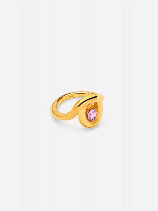Gold Looped Oval Ring with a sculptural wave design, set with a round pink crystal at the center. Side View.
