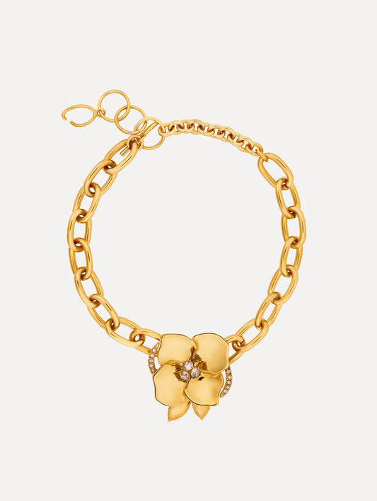 Gold Blossom Chain-Link Necklace featuring a sculpted floral charm with crystal center accents.