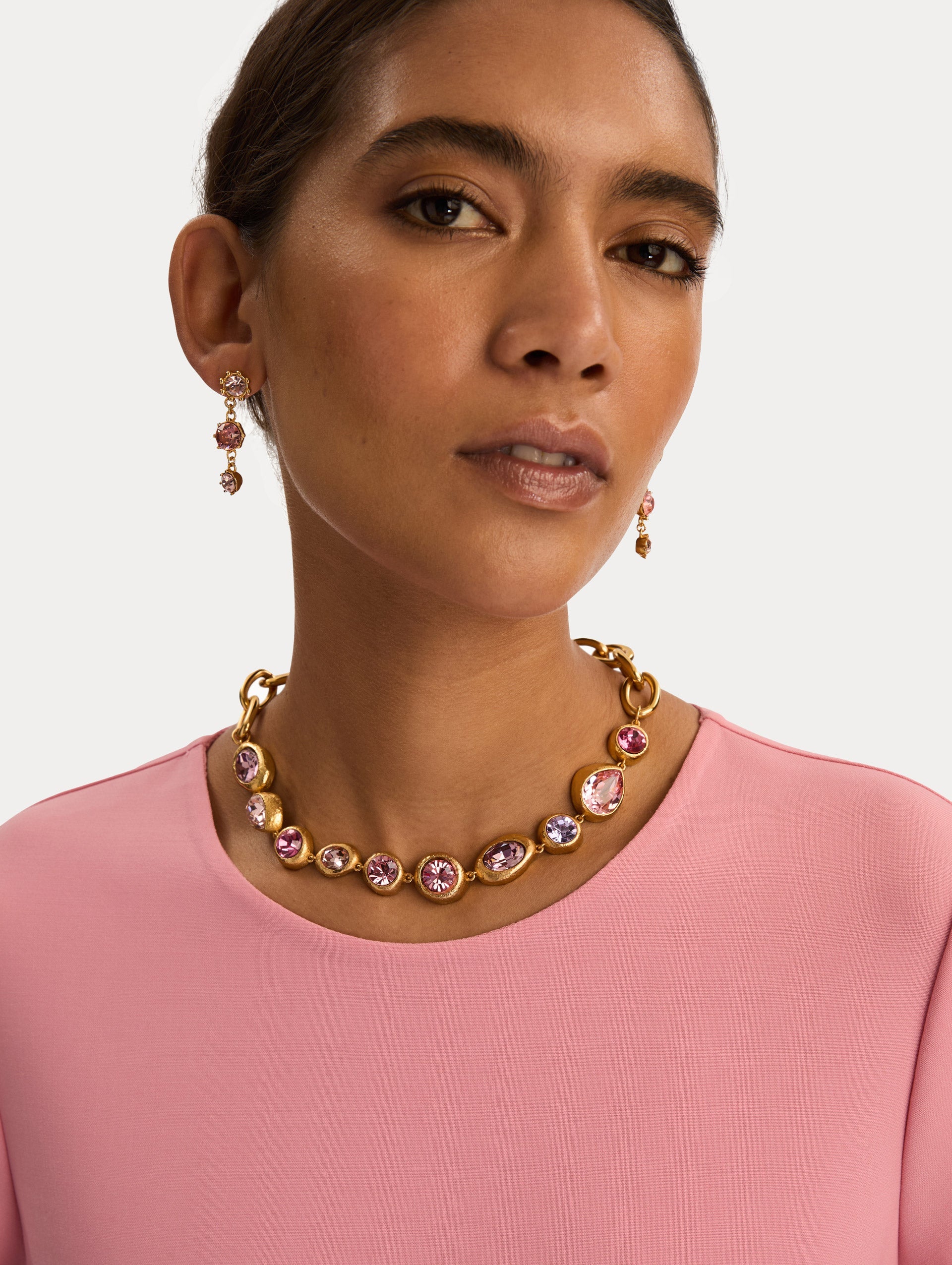 Gold Hammered Chain-Link Necklace featuring bezel-set pink, purple, and lilac crystals in varied cuts. Front View.