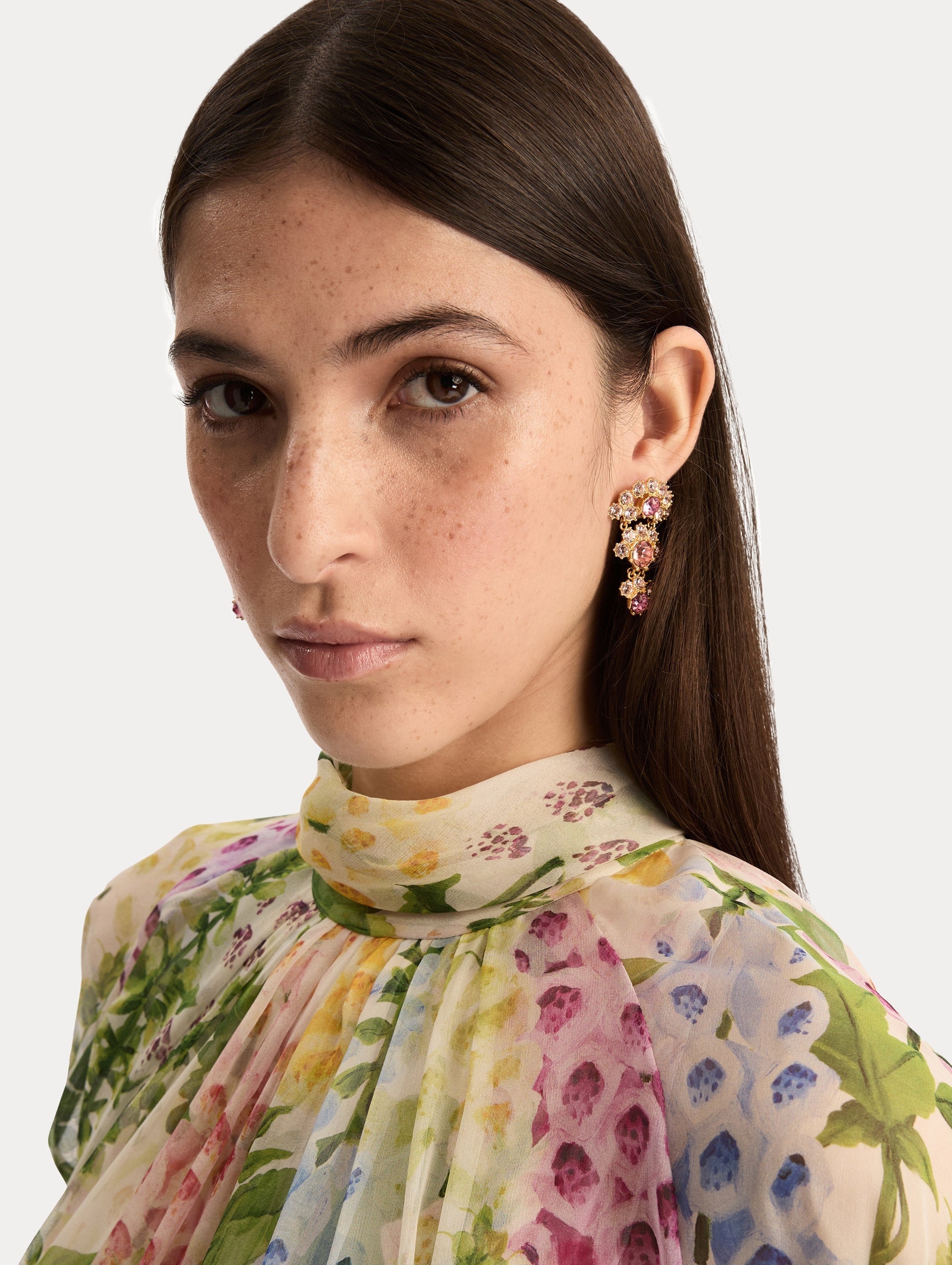 Gold Faceted Crystal Arch Drop Earrings featuring clustered round pink crystals with central darker pink accents. Side View.