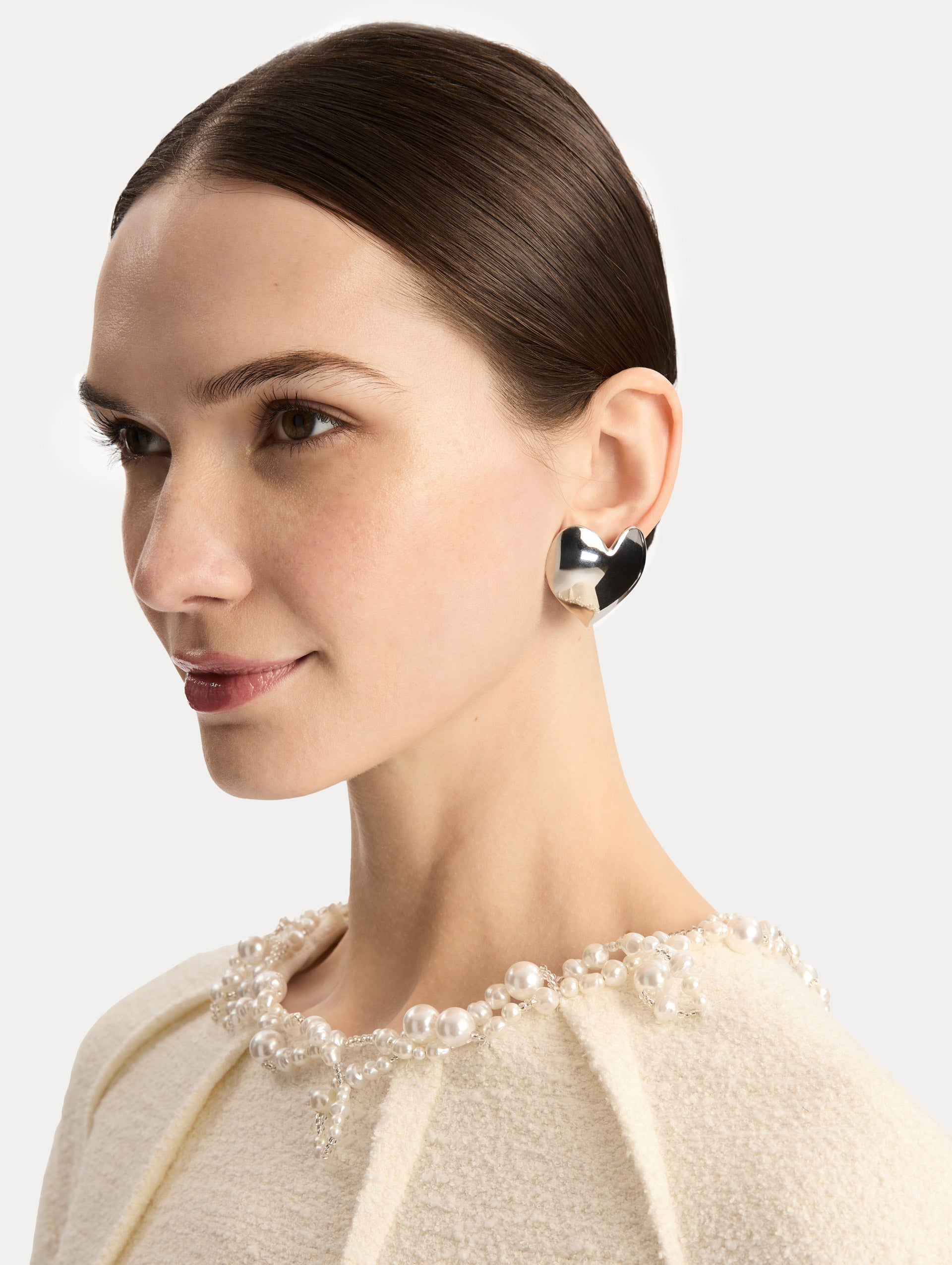 Silver Heart Clip-On Earrings with a smooth finish. Side View.