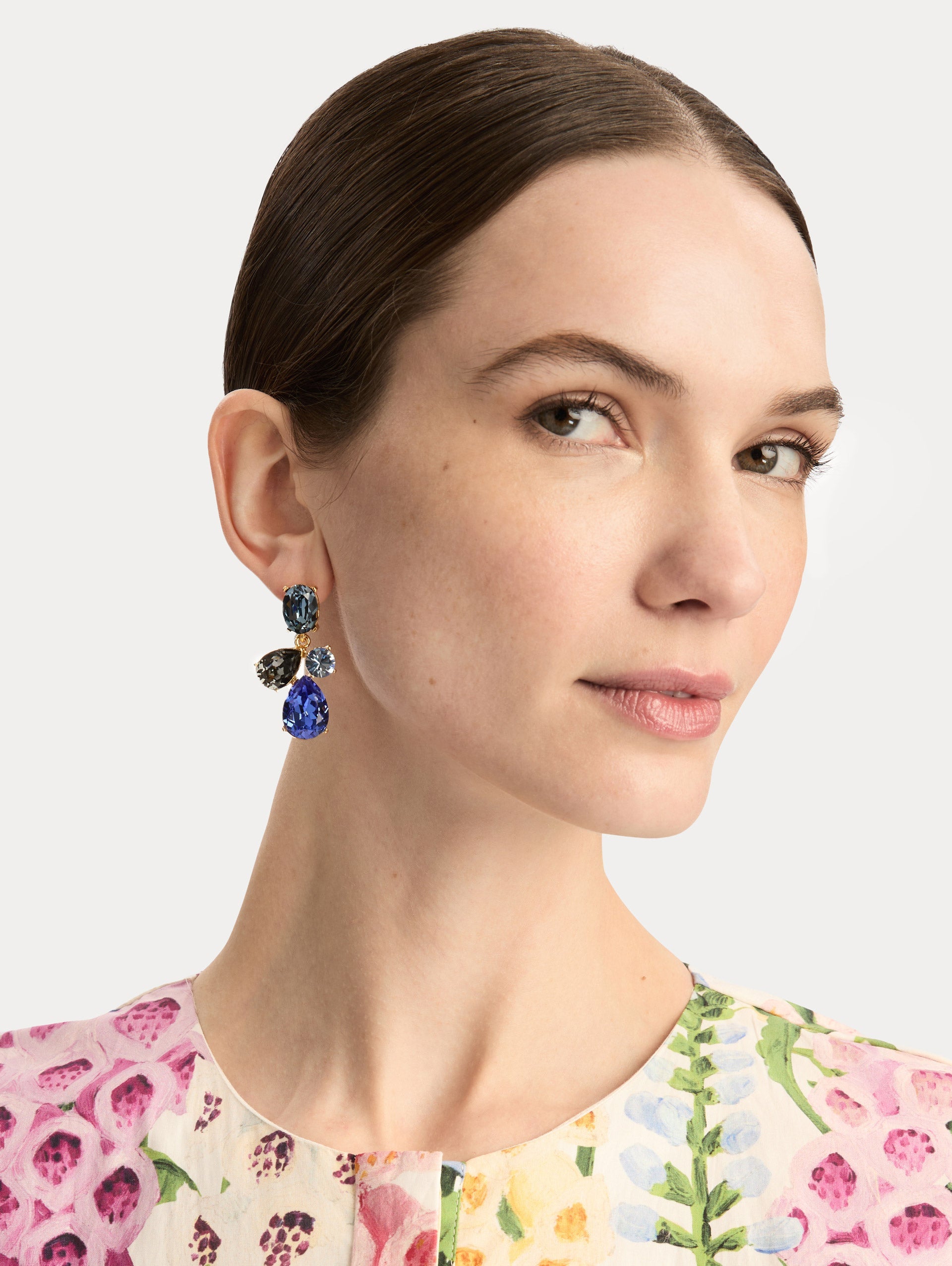 Gold Candy Drop Earrings featuring blue oval studs, green round crystals, pale green teardrops, and emerald teardrop pendants. Front View.