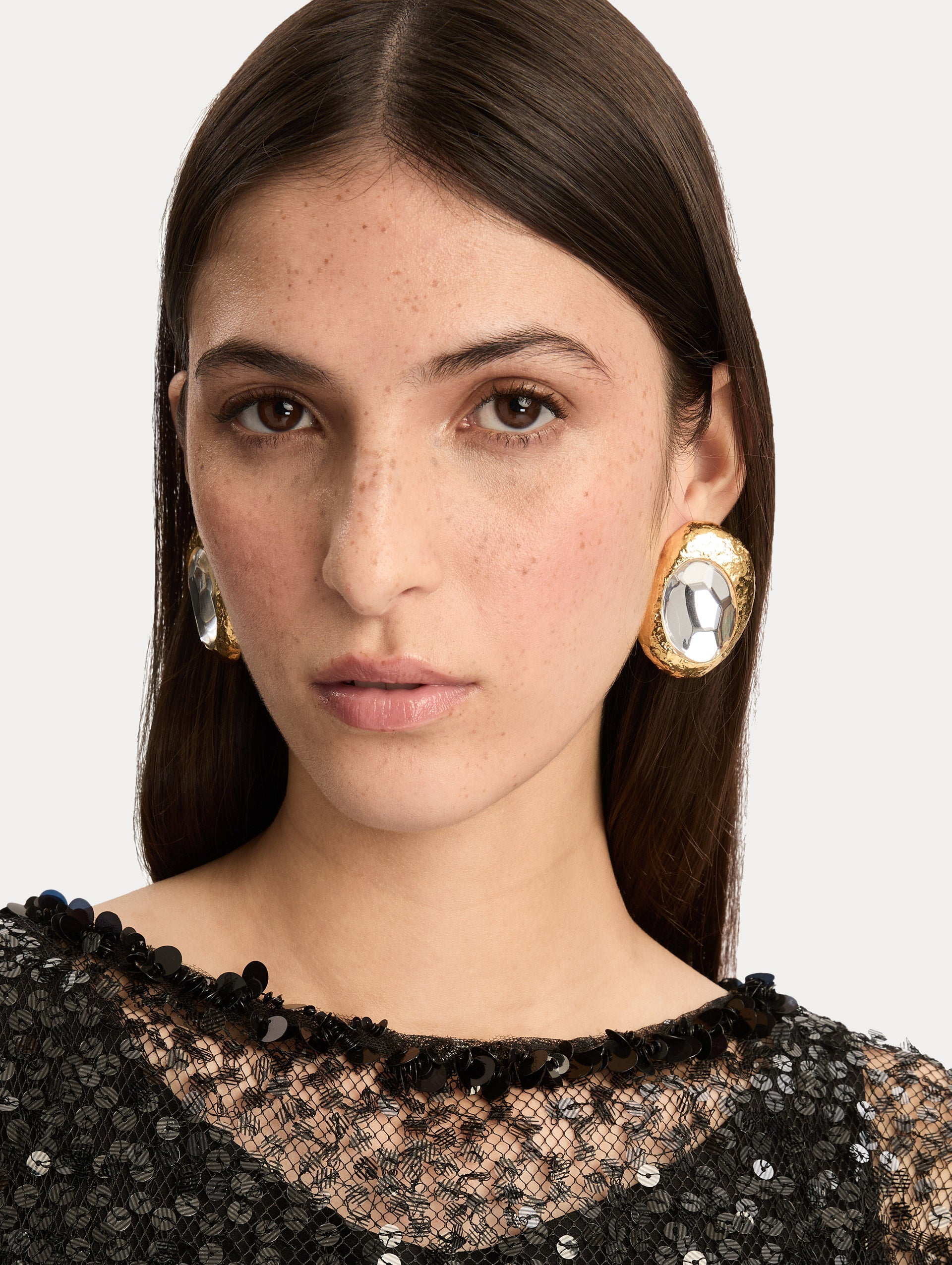Gold Hammered Oval Clip-On Earrings featuring round textured frames with faceted silver-tone centers. Front View.
