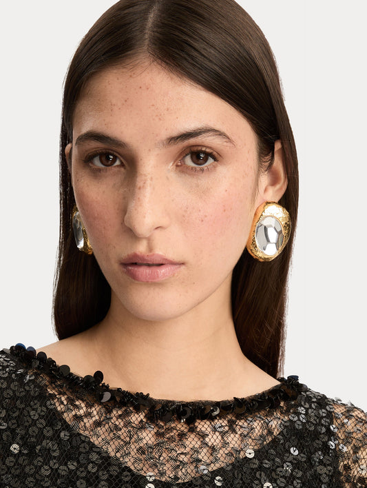Gold Hammered Oval Clip-On Earrings featuring round textured frames with faceted silver-tone centers. Front View.
