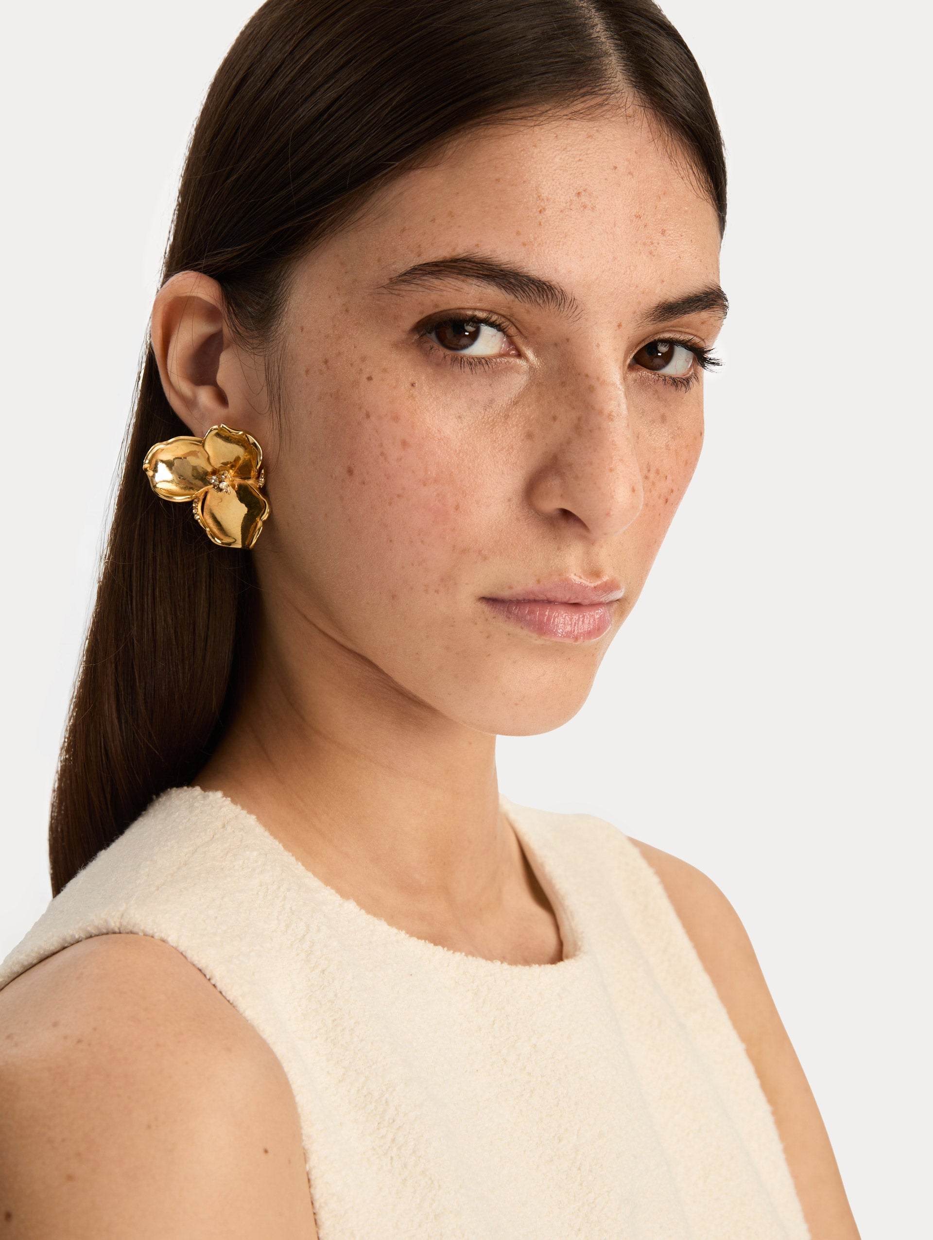 Gold Blossom Earrings featuring petal design with crystal centers. Front View.