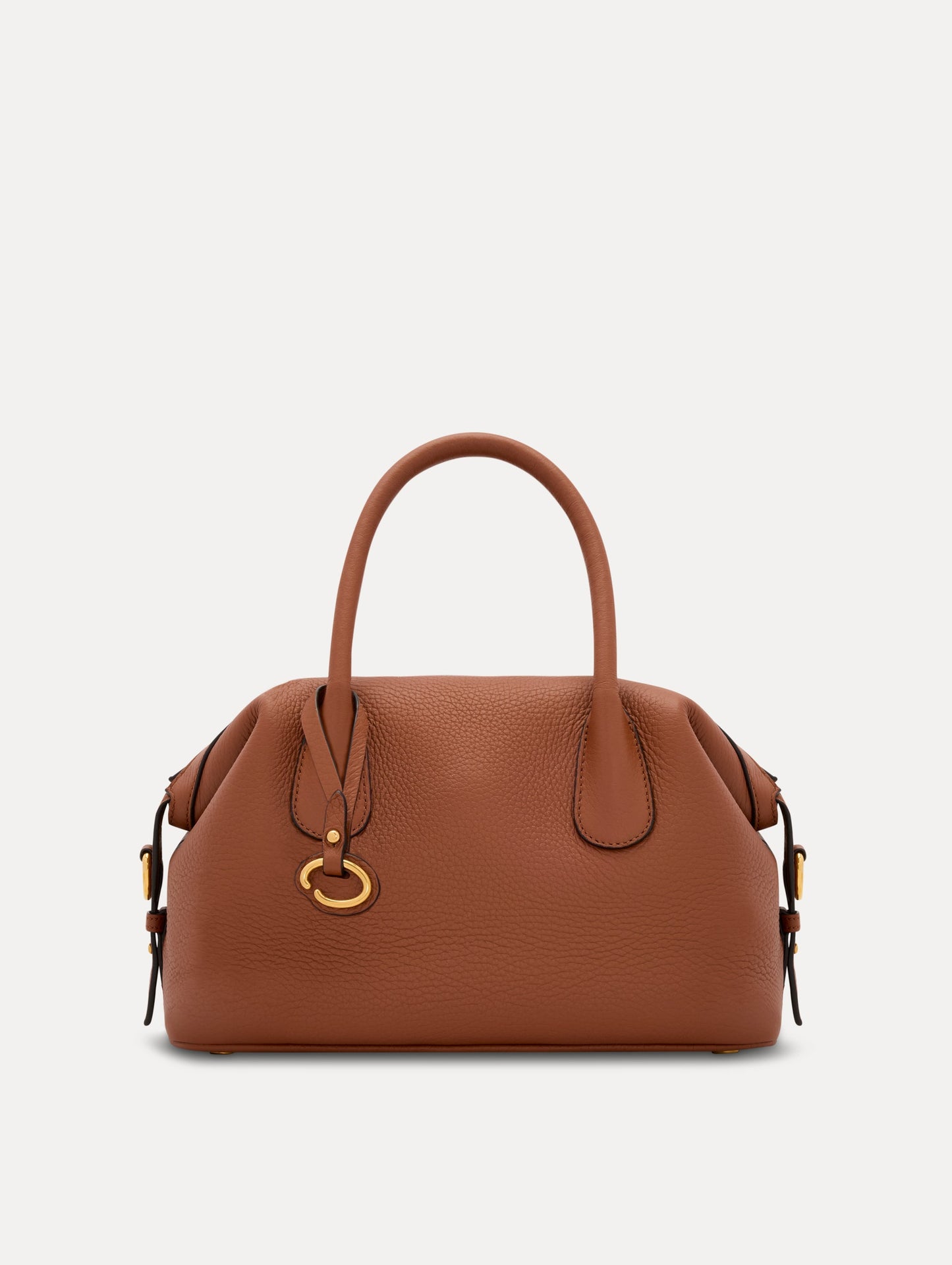 The Mini Dahlia in Cognac Brown. This mini duffle bag has top handles and a removable shoulder strap. Detailed with Oscar de la Renta signature O emblem on the hangtag. Front View