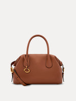 The Mini Dahlia in Cognac Brown. This mini duffle bag has top handles and a removable shoulder strap. Detailed with Oscar de la Renta signature O emblem on the hangtag. Front View