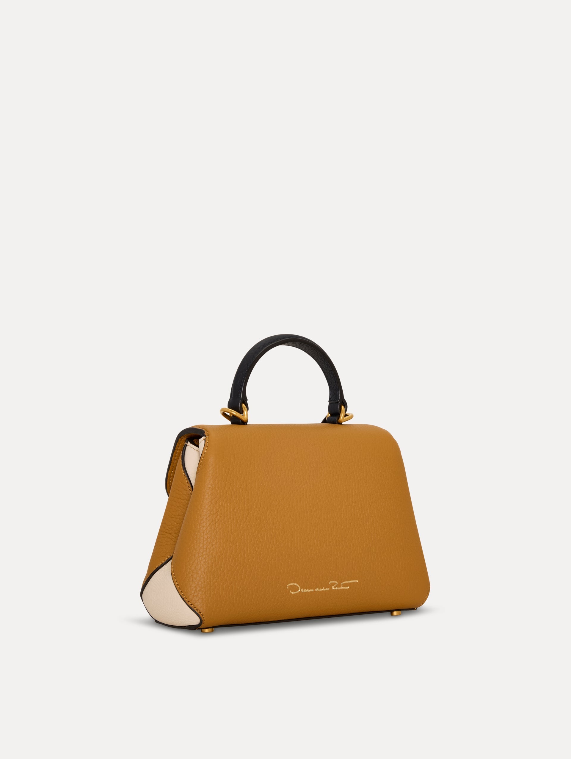 The Mini Poppy Handbag in Honey with Black Top Handle. Side View